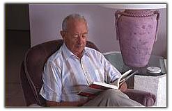 elderly man reading in seniors home